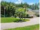 Manicured lawn and brick driveway lead to this well-maintained home, perfect for curb appeal at 10417 Lake Louisa Rd, Clermont, FL 34711