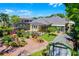 Exterior view of the home showcasing a manicured backyard, pool, and lush landscaping at 10417 Lake Louisa Rd, Clermont, FL 34711