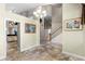 Open-concept foyer with tile flooring, staircase, and elegant decor, leading to multiple rooms at 10417 Lake Louisa Rd, Clermont, FL 34711