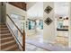 Welcoming foyer featuring stairs, tile floors, and stylish accents, leading to dining and kitchen areas at 10417 Lake Louisa Rd, Clermont, FL 34711