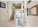 Grand two-story foyer with tile flooring and a staircase at 10417 Lake Louisa Rd, Clermont, FL 34711