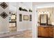 Hallway with tile floors offering access to the kitchen and a bathroom with vanity at 10417 Lake Louisa Rd, Clermont, FL 34711