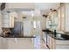 Well-equipped kitchen with stainless steel appliances, granite countertops, and travertine floors at 10417 Lake Louisa Rd, Clermont, FL 34711