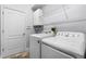 Functional laundry room with modern washer and dryer and ample storage space at 10417 Lake Louisa Rd, Clermont, FL 34711