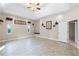 Spacious living room with neutral colors, tile flooring, a ceiling fan, and recessed lighting at 10417 Lake Louisa Rd, Clermont, FL 34711