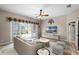 Staged living room with tile flooring and glass sliding doors to a screened-in patio at 10417 Lake Louisa Rd, Clermont, FL 34711