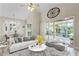 Spacious living room with travertine floors and comfortable seating arrangement with screened in porch access at 10417 Lake Louisa Rd, Clermont, FL 34711
