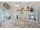 Living room with stone fireplace, built-in display cabinet, and access to the screened in patio at 10417 Lake Louisa Rd, Clermont, FL 34711