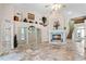 Living room with stone fireplace, built-in display cabinet, and staircase at 10417 Lake Louisa Rd, Clermont, FL 34711