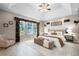 Staged main bedroom with trey ceiling, transom windows, and decorative window treatments at 10417 Lake Louisa Rd, Clermont, FL 34711