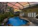 Enclosed backyard pool featuring rock accents, a patio, and lots of space to relax at 10417 Lake Louisa Rd, Clermont, FL 34711