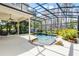 View of a screened pool area with beautiful landscaping and a covered patio for outdoor enjoyment at 10417 Lake Louisa Rd, Clermont, FL 34711