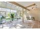 Bright sunroom featuring tile floors, a ceiling fan, and wall to wall windows offering abundant natural light at 10417 Lake Louisa Rd, Clermont, FL 34711