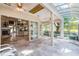 Bright sunroom featuring a fireplace and tile flooring at 10417 Lake Louisa Rd, Clermont, FL 34711
