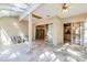 Bright sunroom with a vaulted glass ceiling and tile flooring at 10417 Lake Louisa Rd, Clermont, FL 34711