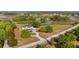 Breathtaking aerial of a grand home featuring meticulous landscaping and a long, winding driveway at 10651 Arrowtree Blvd, Clermont, FL 34715