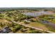 Aerial view of an elegant estate home with a private driveway and serene natural surroundings at 10651 Arrowtree Blvd, Clermont, FL 34715