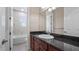 Bathroom featuring granite countertop vanity, with tub and toilet in the background at 10651 Arrowtree Blvd, Clermont, FL 34715