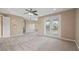 Large bedroom featuring neutral walls, carpet floors, balcony doors, and a tray ceiling at 10651 Arrowtree Blvd, Clermont, FL 34715