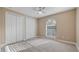 Bedroom featuring a ceiling fan, window with blinds and double door closet at 10651 Arrowtree Blvd, Clermont, FL 34715