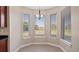 Charming breakfast nook featuring large windows with views and a stylish hanging light fixture at 10651 Arrowtree Blvd, Clermont, FL 34715
