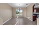 Dining room featuring tile floors, view to backyard, and stylish light fixture at 10651 Arrowtree Blvd, Clermont, FL 34715