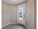 Entryway view featuring tile flooring, neutral walls, and glass panel front door at 10651 Arrowtree Blvd, Clermont, FL 34715