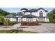 Beautiful exterior elevation of a modern residence with a circular driveway and manicured landscaping at 10651 Arrowtree Blvd, Clermont, FL 34715