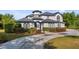 Stunning two-story home with a circular driveway and manicured landscaping at 10651 Arrowtree Blvd, Clermont, FL 34715