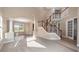 Spacious foyer with grand staircase, tile flooring, and abundant natural light at 10651 Arrowtree Blvd, Clermont, FL 34715