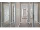 Mirrored closets in the hallway lead to a luxurious bathroom with tile floors and a relaxing jacuzzi tub at 10651 Arrowtree Blvd, Clermont, FL 34715