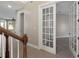 Upstairs hallway featuring french doors leading to a bonus room at 10651 Arrowtree Blvd, Clermont, FL 34715