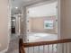 Hallway leads to a carpeted bedroom, with a bathroom on the left, featuring bright natural light at 10651 Arrowtree Blvd, Clermont, FL 34715