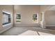 Bright living room featuring neutral walls, carpet, large windows, and views of the yard at 10651 Arrowtree Blvd, Clermont, FL 34715