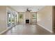 Inviting living room with a cozy fireplace, neutral walls, and large windows for natural light at 10651 Arrowtree Blvd, Clermont, FL 34715
