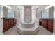 Expansive main bathroom boasting dual vanities, a luxurious tub, and lots of natural light at 10651 Arrowtree Blvd, Clermont, FL 34715