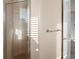 Shower with a glass door, tiled walls and floor, and natural light at 10651 Arrowtree Blvd, Clermont, FL 34715