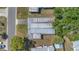 An aerial shot depicts the home with a sturdy metal roof and mature trees at 1112 Elkhart Cir, Tavares, FL 32778