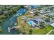 View of the pool, lake, shuffleboard courts, and surrounding community at 1112 Elkhart Cir, Tavares, FL 32778