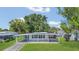 Charming single-story home boasts a well-maintained lawn and covered parking at 1112 Elkhart Cir, Tavares, FL 32778