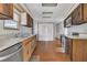Traditional kitchen featuring wood cabinets, white countertops, and modern stainless steel appliances at 1112 Elkhart Cir, Tavares, FL 32778
