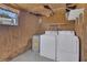 Laundry room with washer, dryer, and water heater with shelving and lighting at 1112 Elkhart Cir, Tavares, FL 32778