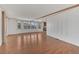 Living room with hardwood floors, neutral walls, and abundant natural light through windows at 1112 Elkhart Cir, Tavares, FL 32778