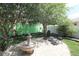 Serene backyard retreat with a beautiful stone fountain and comfortable seating area for relaxation at 1135 Easley Way, The Villages, FL 32162