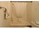 The clean and classic bathroom features a shower and tub combination with essential towel racks at 1135 Easley Way, The Villages, FL 32162