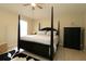 Spacious bedroom with a four-poster bed, a ceiling fan, and tiled floors at 1135 Easley Way, The Villages, FL 32162