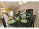 Elegant dining room with a dark wood table, complemented by vibrant floral accents at 1135 Easley Way, The Villages, FL 32162