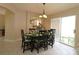 Cozy dining area with stylish table setting and access to kitchen at 1135 Easley Way, The Villages, FL 32162