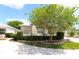 Beautiful home featuring a beige exterior, lush landscaping, and a cozy feel at 1135 Easley Way, The Villages, FL 32162