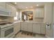 Well-lit kitchen featuring white cabinetry, modern appliances, and plenty of counter space at 1135 Easley Way, The Villages, FL 32162